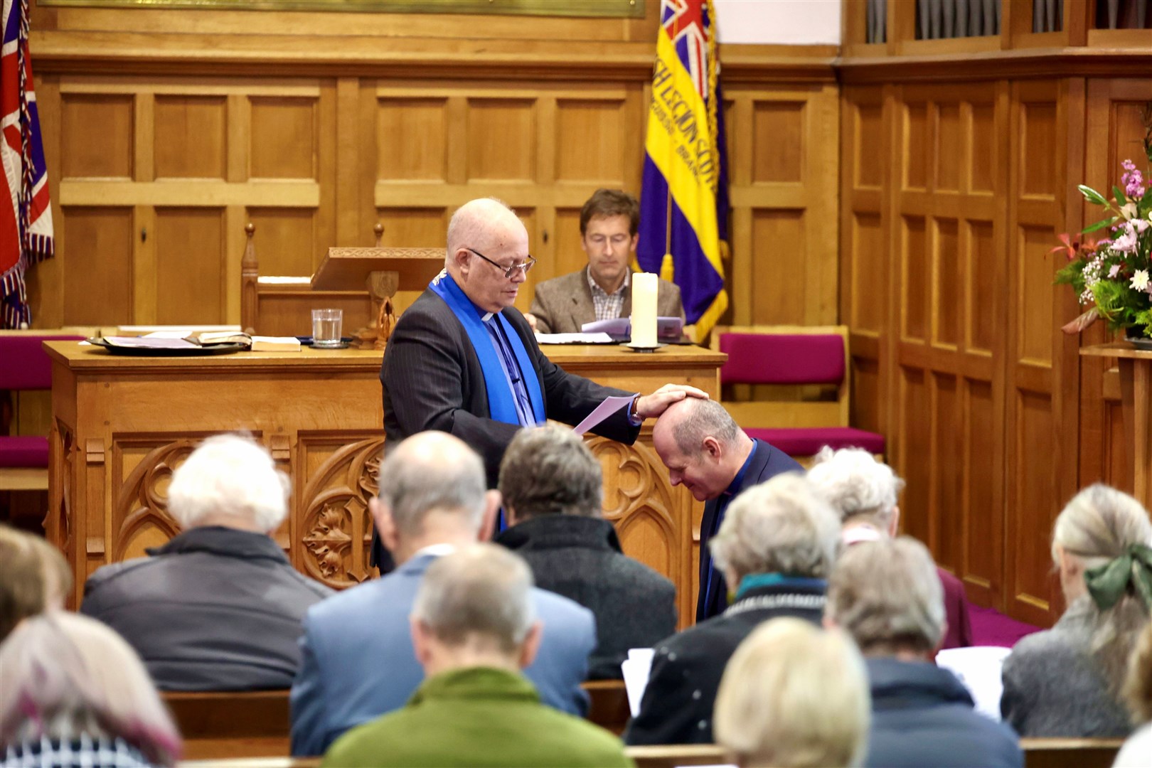 INDUCTED: Rev Brookes (kneeling) and Moderator Doug McRoberts in Kingssie Parish Church last Saturday