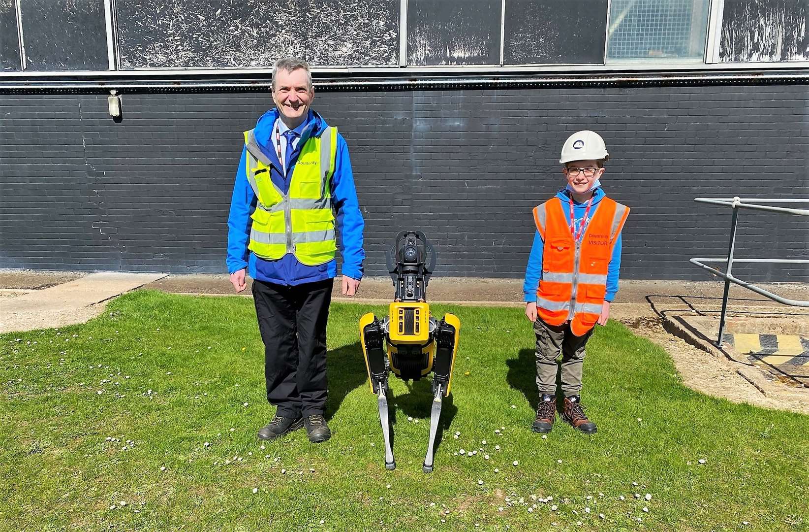 Dounreay innovation manager Gordon Tait with young Robbie and a dog-like robot called Spot that was put through its paces on the day. Picture: DSRL
