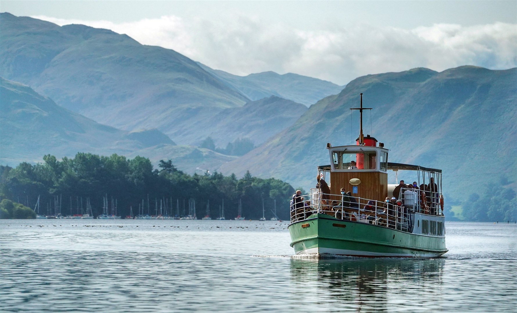 A steamer approaches Pooley Bridge on Ullswater in Cumbria (Owen Humphreys/PA)