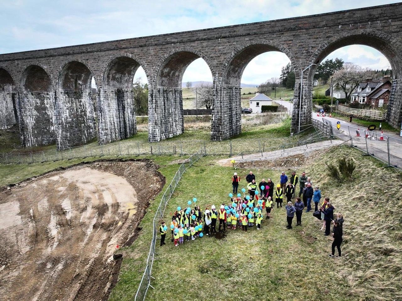 Pupils from Strathdearn Primary School officially break ground on the site, which is next to the railway viaduct at the northern end of Tomatin.