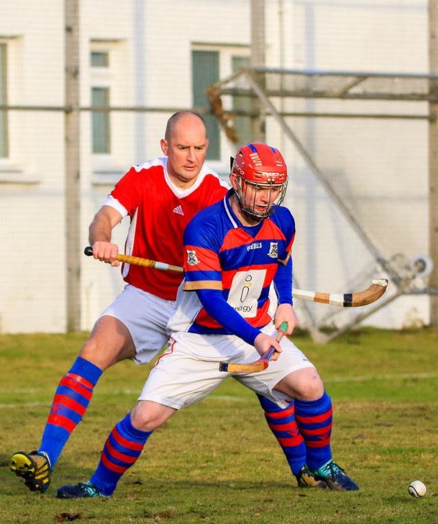 Forward Savio Genini blocks the ball from Ali Macleod.