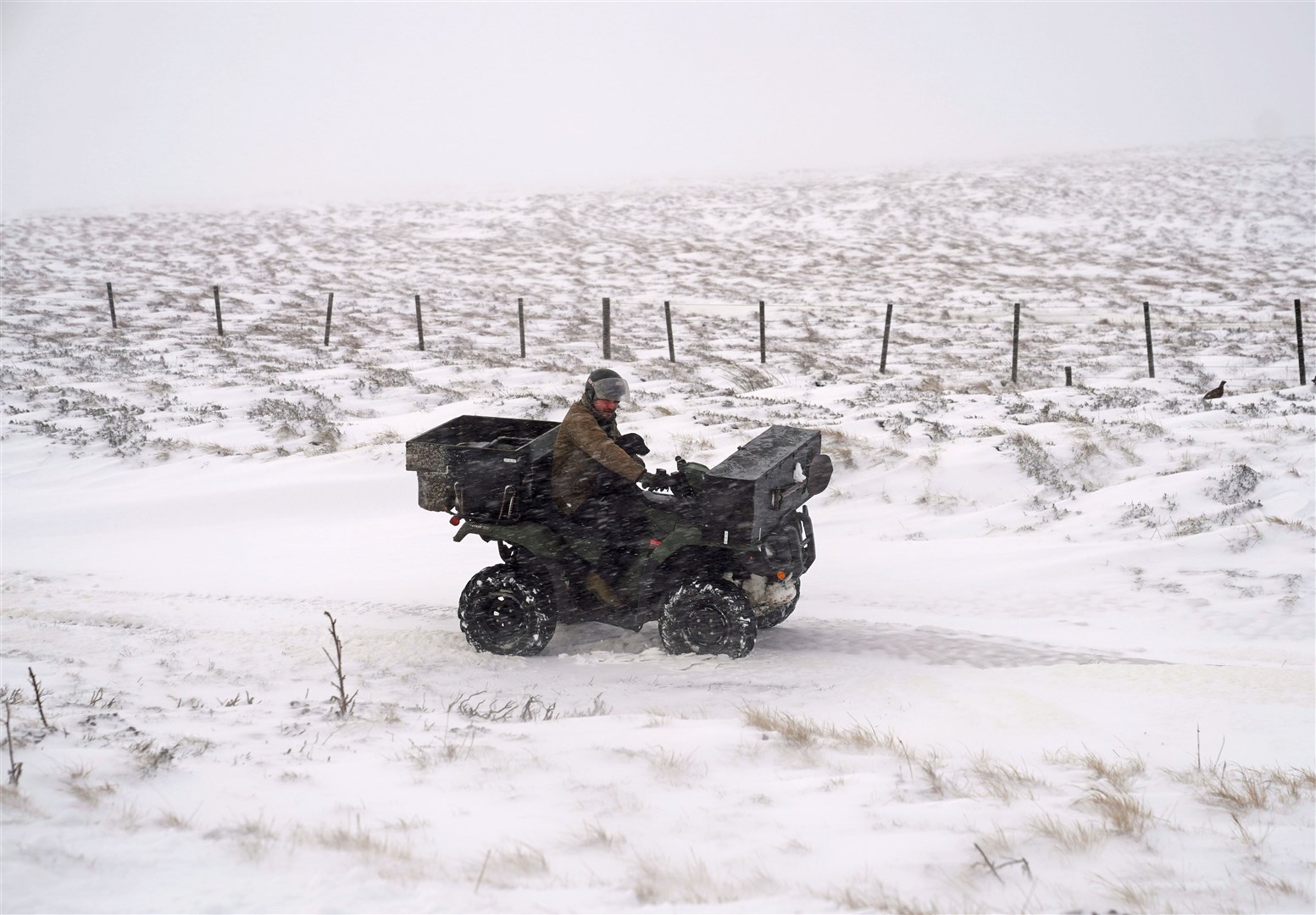 A quad bike helped this man get through the snow in Allenheads (Owen Humphreys/PA)