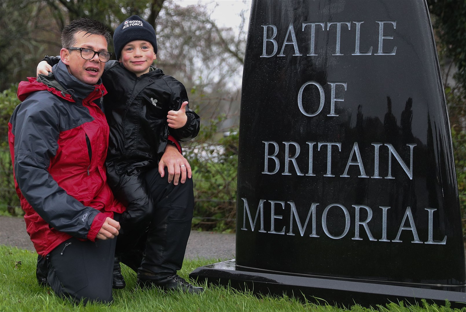 Jacob Newson, on his seventh birthday, poses for a photograph with his dad Andrew (left) after arriving at the Battle of Britain Memorial. (PA).