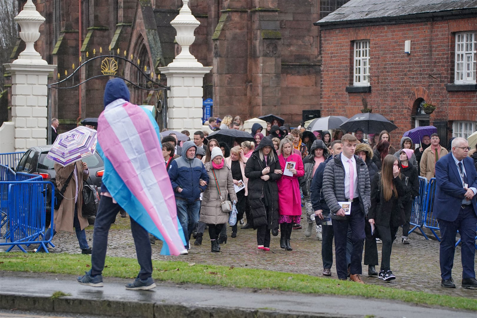 A trans flag was carried by one of the mourners (Peter Byrne/PA)