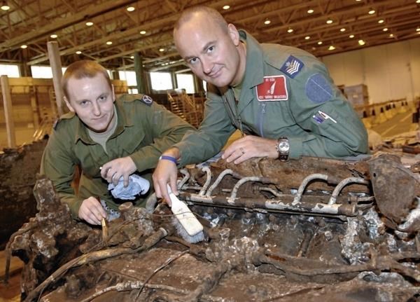Senior Aircraftsman Dan Nolan (left) and Flight Sergeant Kev Brunsden clean up a recovered part of the bomber