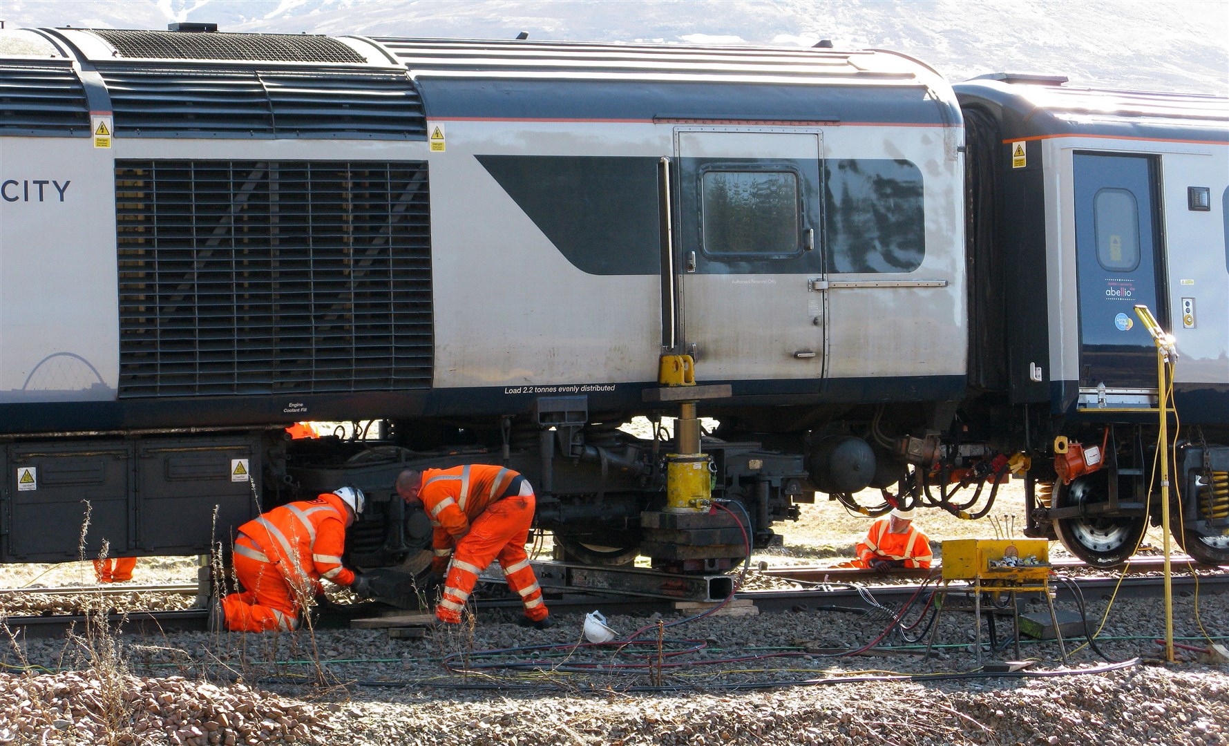 Engineers work to correct the wheel allignments and the track at Dalwhinnie