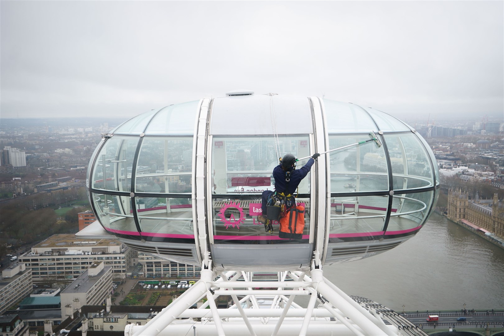 The cleaning crew wore harnesses and protective gear to scale the London landmark (James Manning/PA)