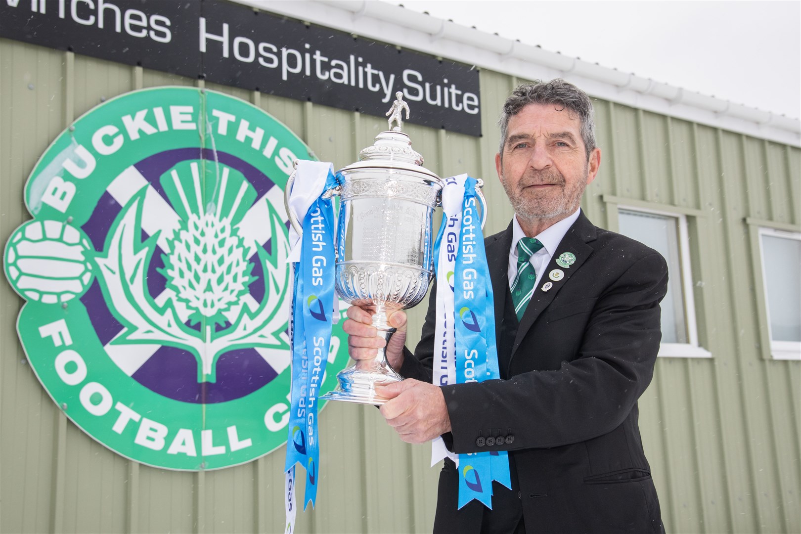 Buckie Thistle president Garry Farquhar gets his hands on the famous old trophy. Picture: Daniel Forsyth.