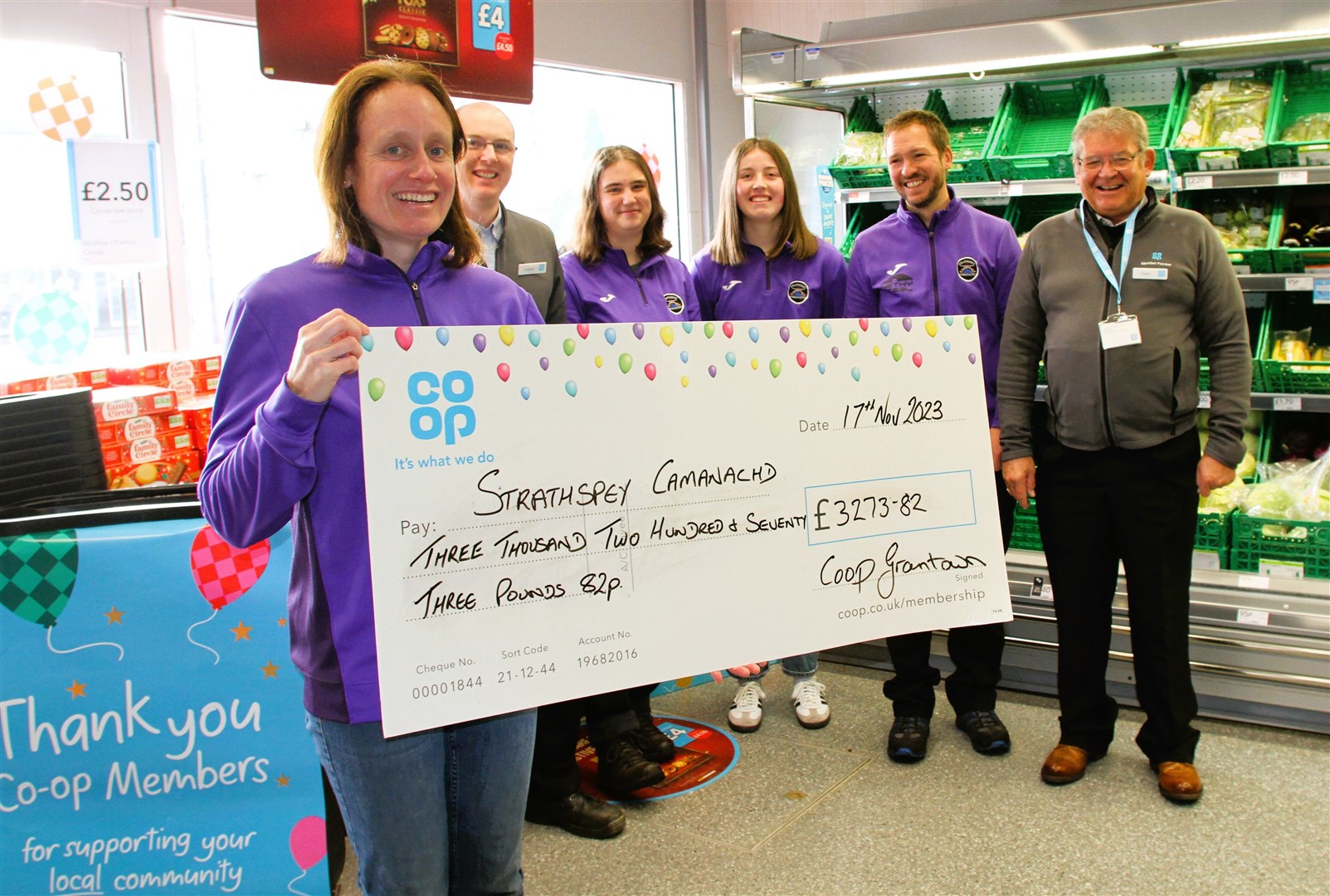 Lucy Davies, Bob Davies, Charlotte Bissett and Clair Filer from Strathspey Camanachd with Co-op officials Graham Shand and Ewan MacGregor.