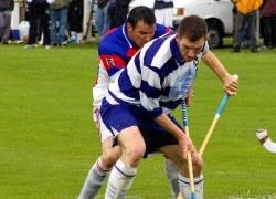 The Kings’ Rory Fraser and Newtonmore’s Fraser Mackintosh try to get to grip with the wet conditions at the Eilan on Saturday.