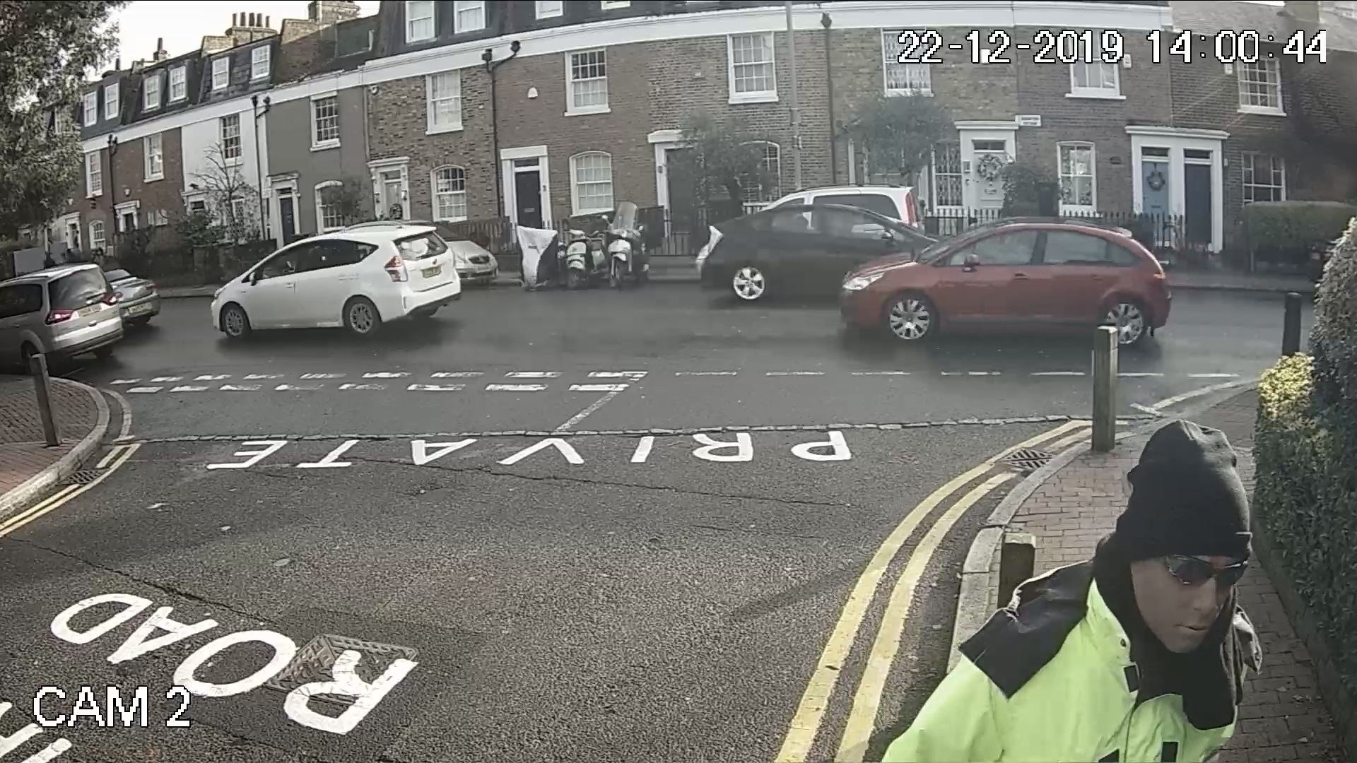Anis Hemissi wearing a latex mask and dressed as a street cleaner outside Flamur Beqiri’s home in London (PA)
