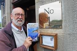Author of The Finest Road in the World, pictured on the shortest street in the world: James Miller in Ebenezer Place, Wick, after his illustrated talk at Mackays Hotel.