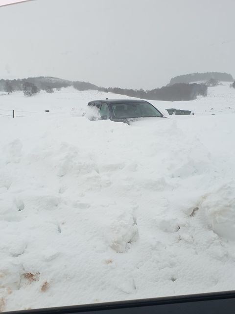 A car pictured at the weekend nearly covered in a snowdrift near Nethy Bridge. Photo: Claire Mccusker