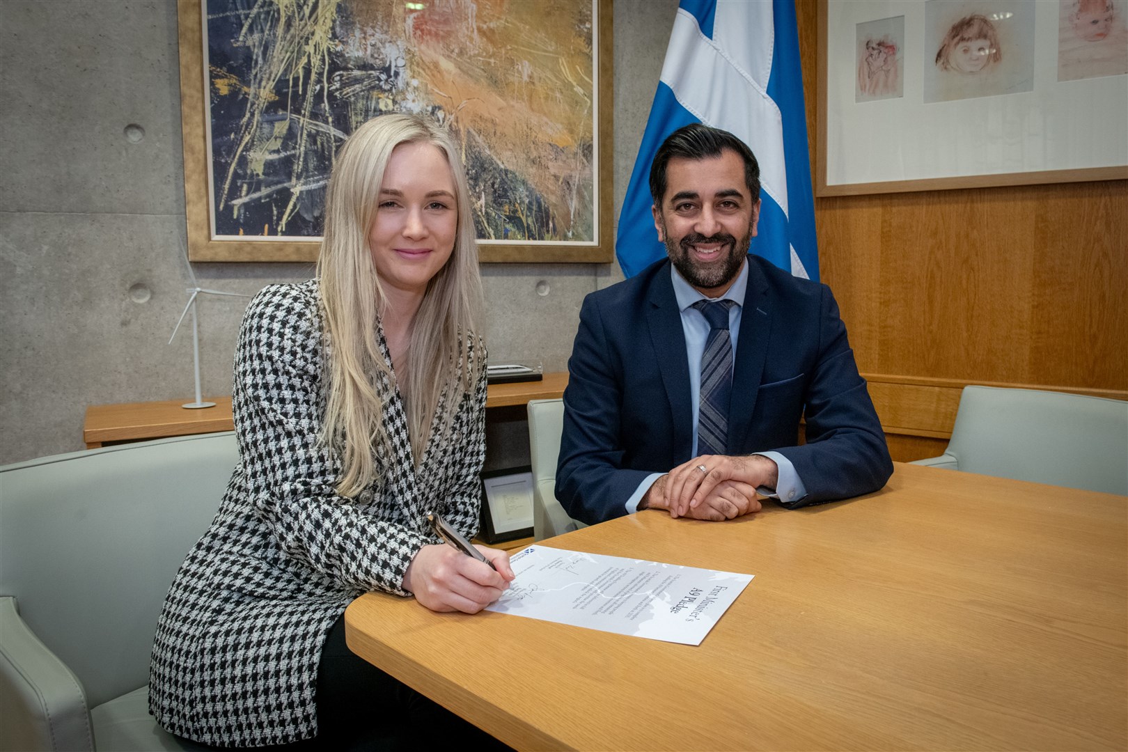 Sarha Fyfe HNM signing the A9 Pledge and First Minister Humza Yousaf. Picture: Callum Mackay..