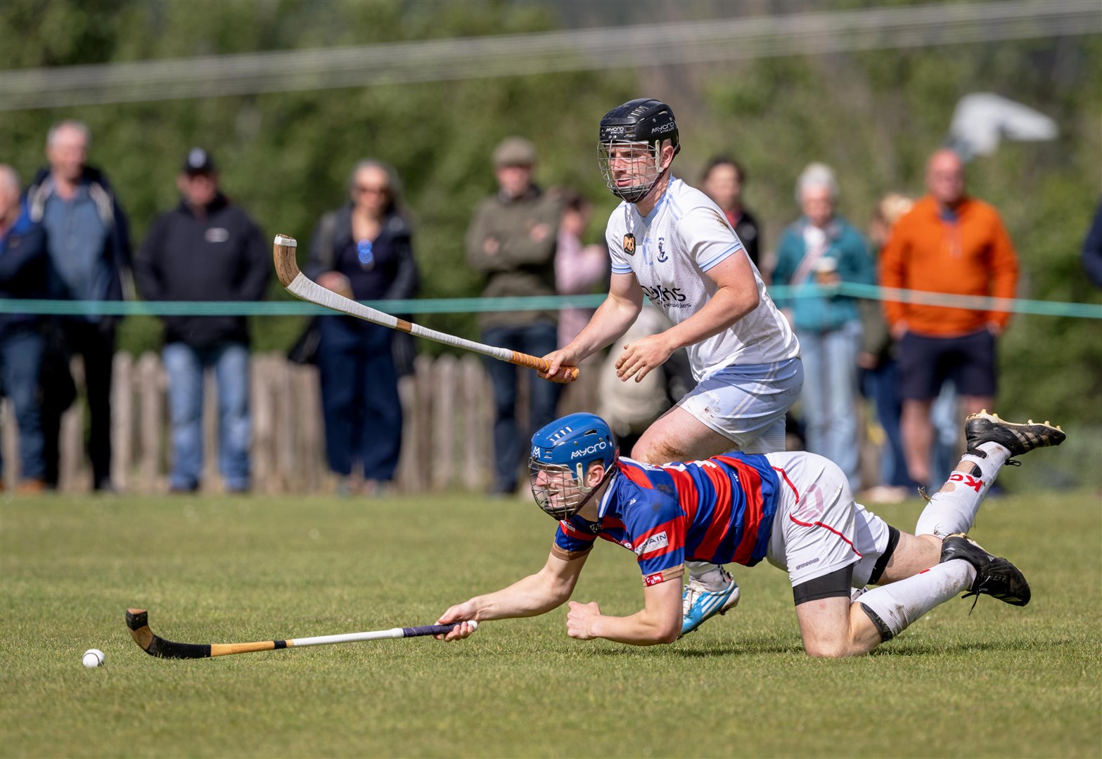 Kingussie's Robert Mabon (front) lunges for the ball ahead of Dan MacDonald (Skye) in the Tulloch Homes Camanachd Cup second round played at Portree. Picture: Neil Paterson.
