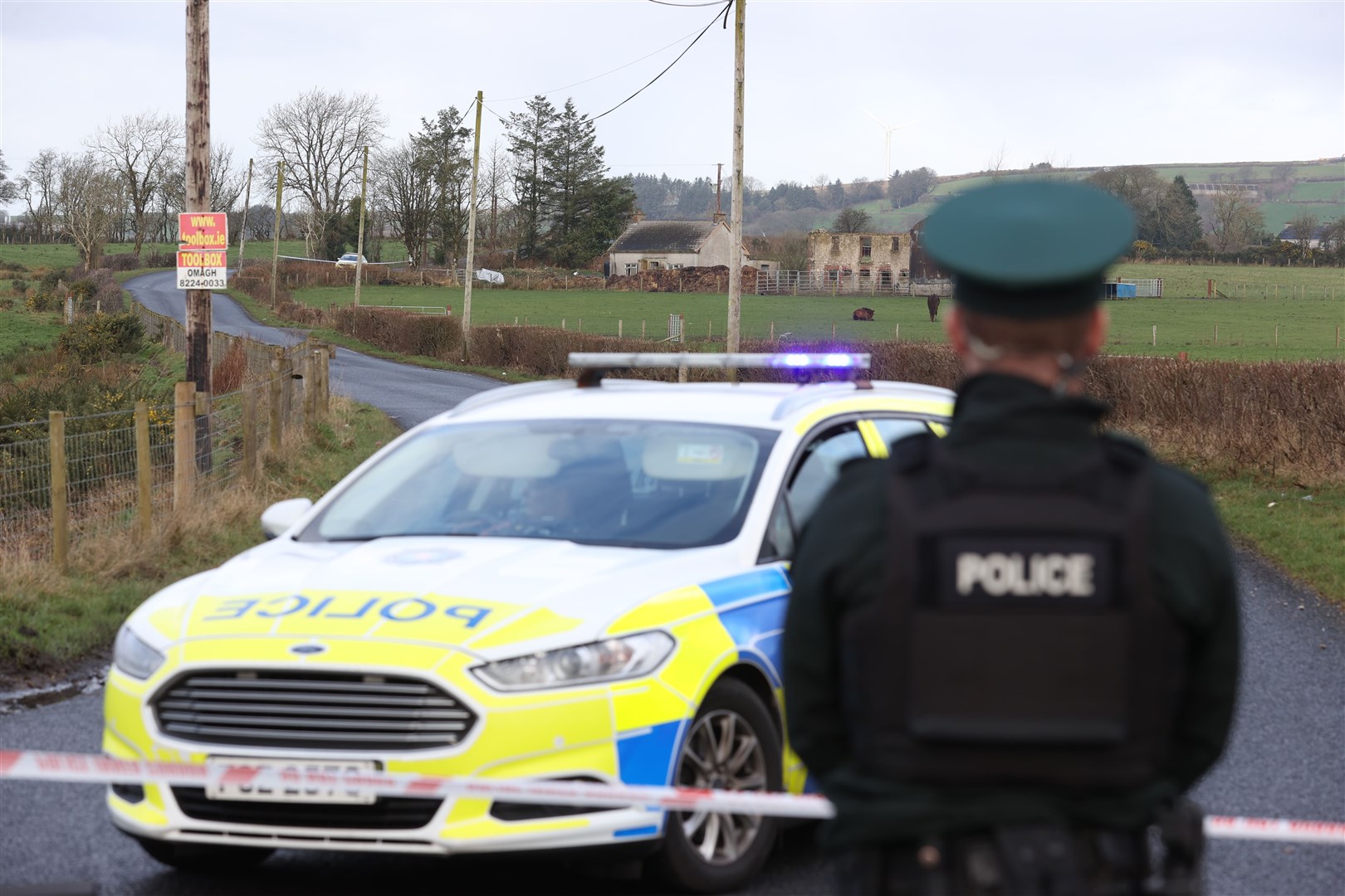 A police cordon near a property on Racolpa Road in Drumnakilly, where a vehicle was burned out overnight (Liam McBurney/PA)