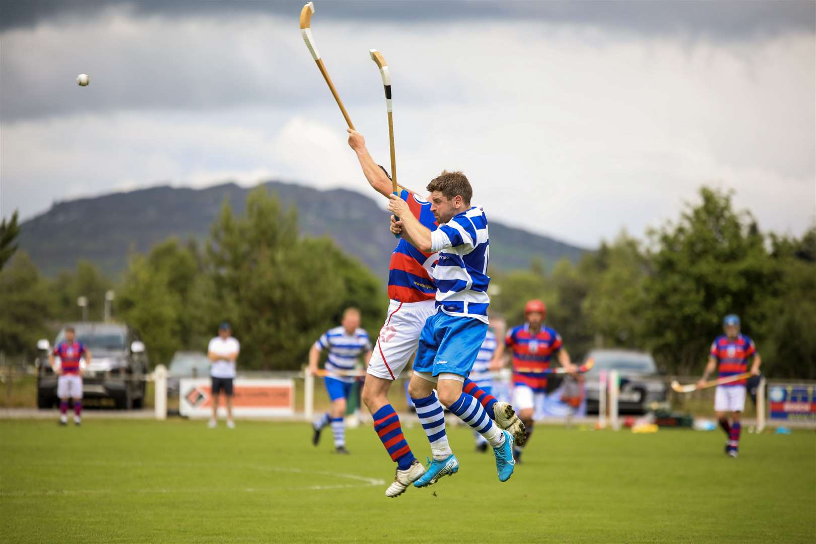 THROW UP NO.1: The derby season gets under way at the Eilan in Newtonmore. Newtonmore's Drew MacDonald (blue and white) was soon battling it out with Kingussie's Fraser Munro
