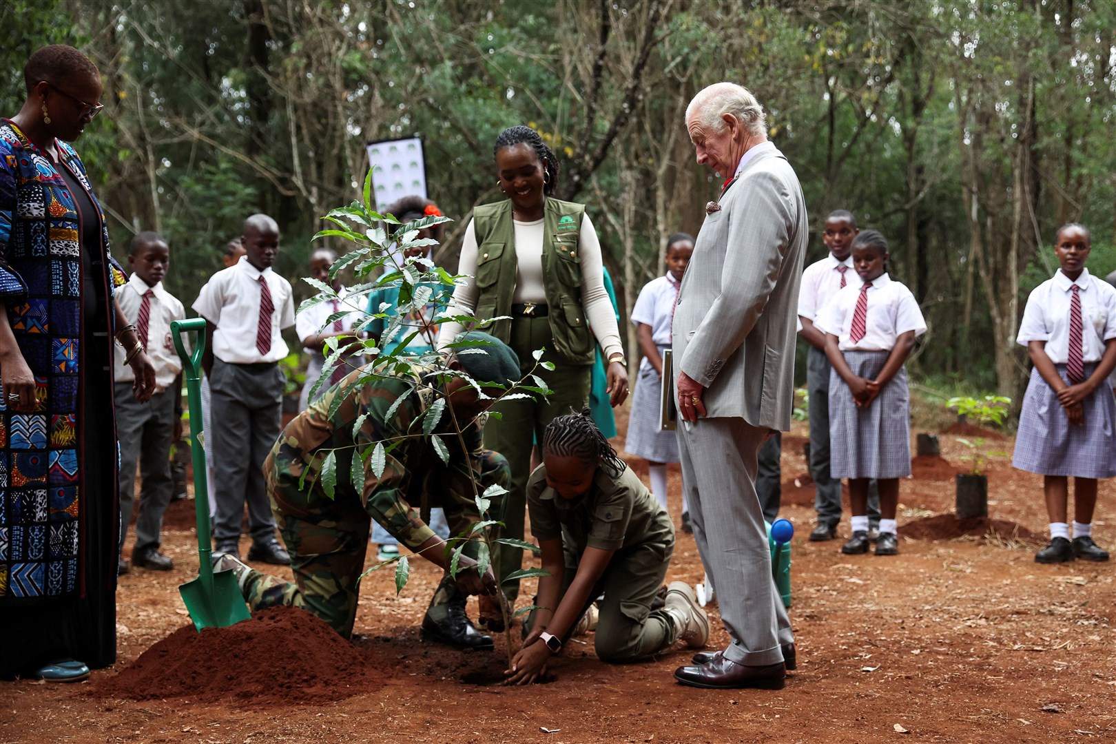 Charles plants a tree with young environmental activist Karen Kimani during a visit to the Karura Forest in Nairobi (Phil Noble/PA)
