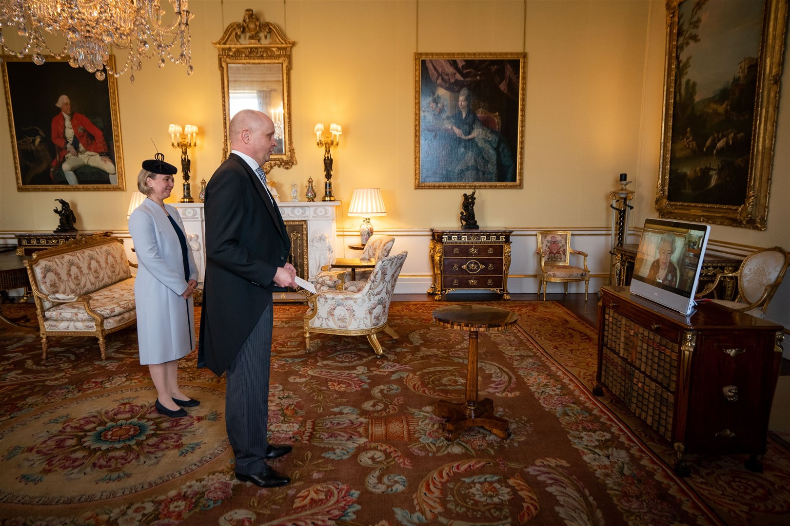 The Finnish ambassador at Buckingham Palace during the audience – with the Queen on screen (Aaron Chown/PA)