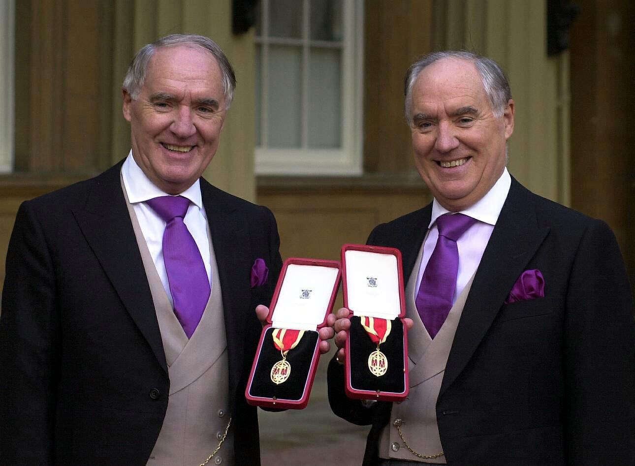 Sir Frederick Barclay, right, with his twin brother, Sir David, after they were knighted (Michael Stephens/PA)