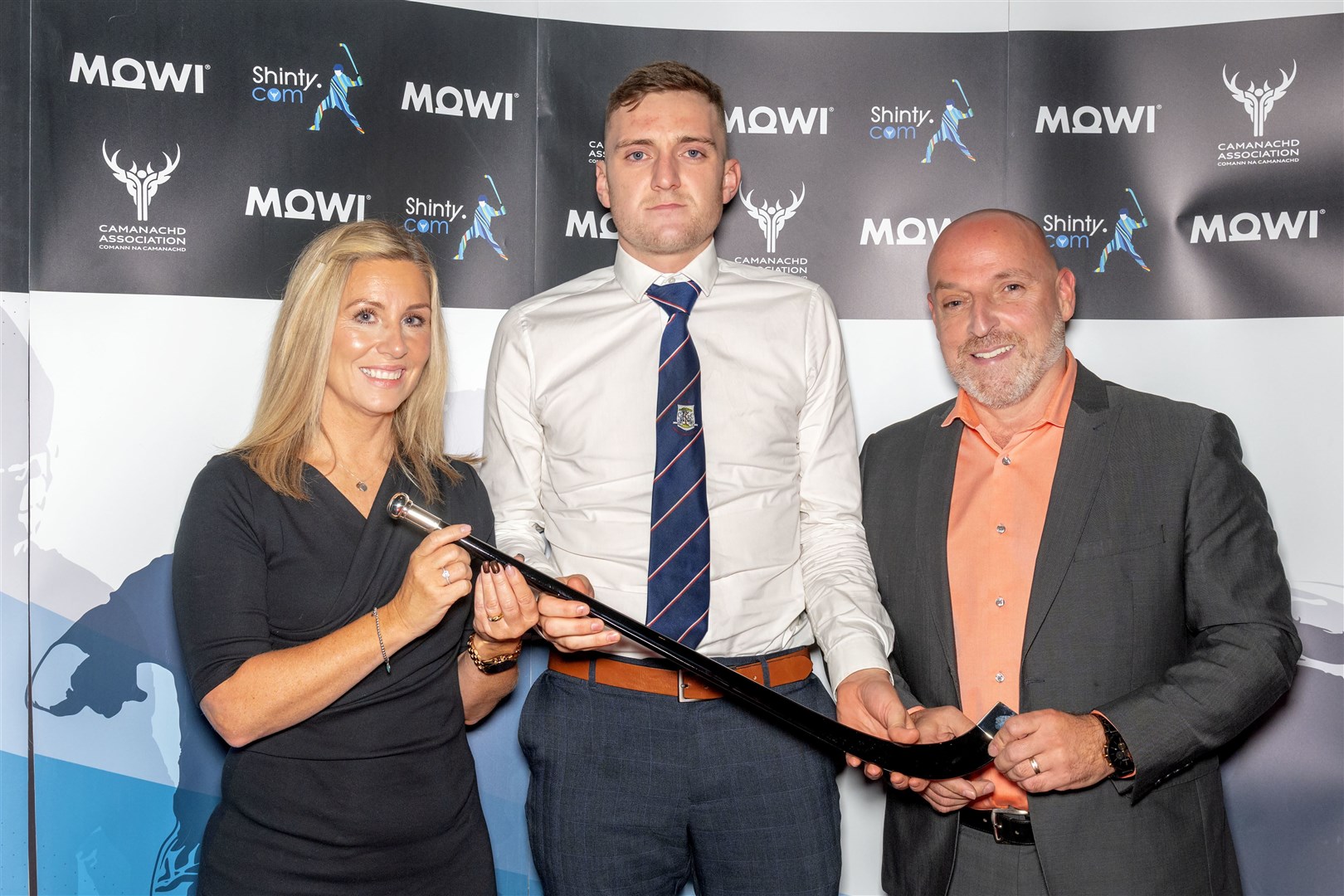 Kingussie’s Robert Mabon receives his Player of the Year Premiership & National award from Mowi’s Jayne MacKay and Ian Roberts.