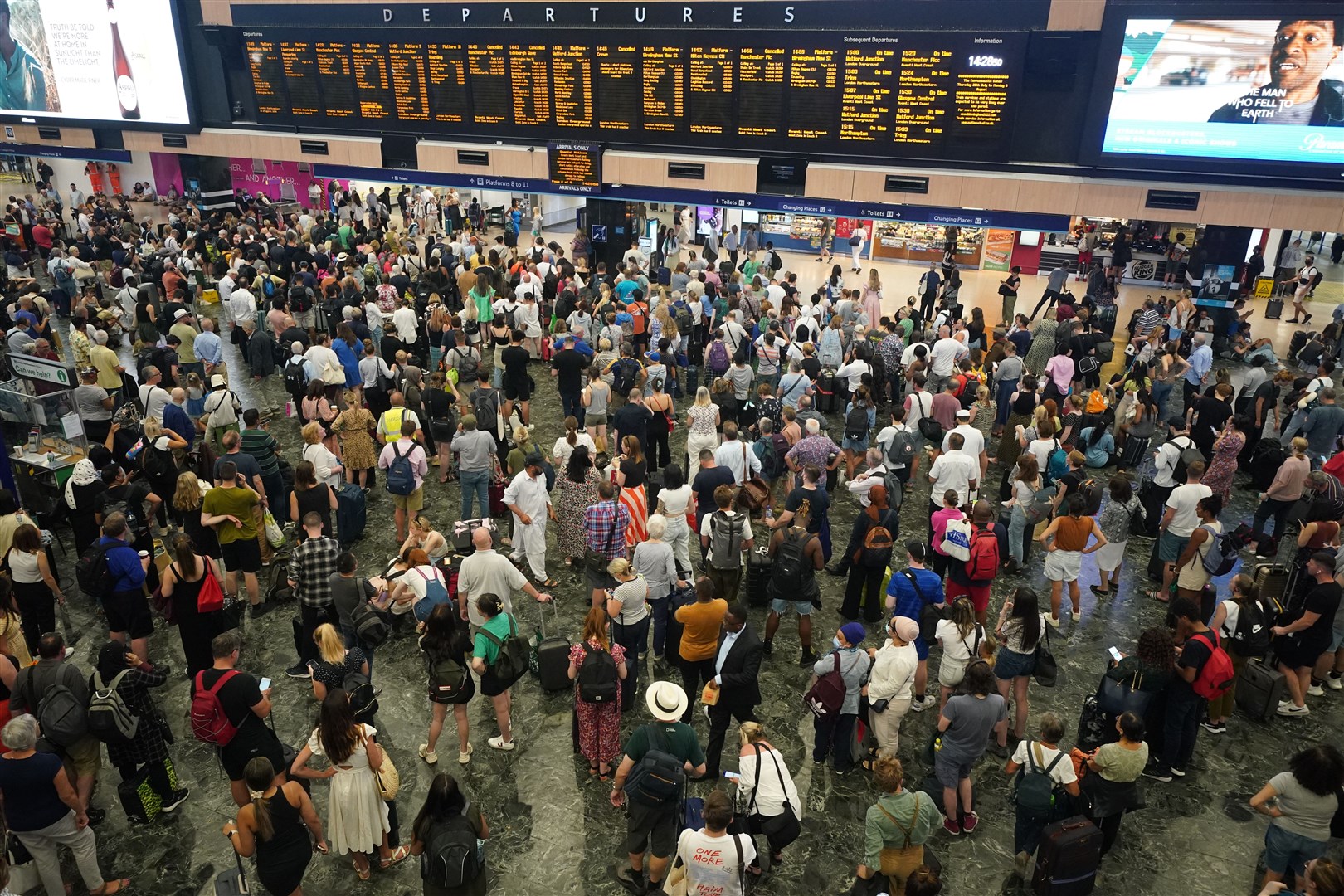 Passengers at Euston station in London following train cancellations in the summer (PA)