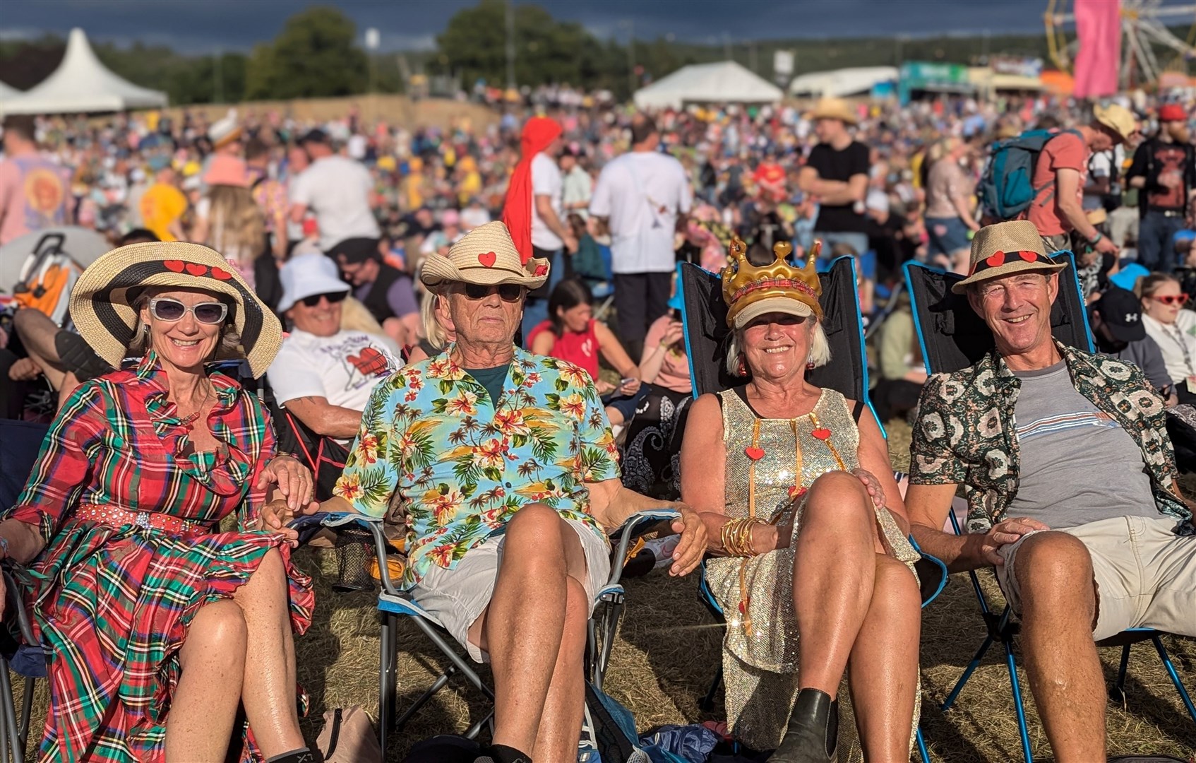 A group of friends spreading the love with a tartan dress and mixture of fun hats.
