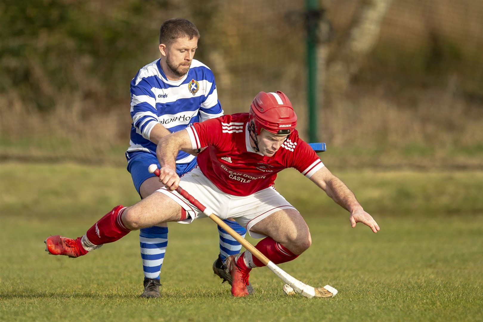 Darrin Fowler (Newtonmore) with Keith Macrae (Kinlochshiel) earlier in the opening fixture of the MOWI Premiership season played at Rearaig, Balmacara. Picture: Neil Paterson.