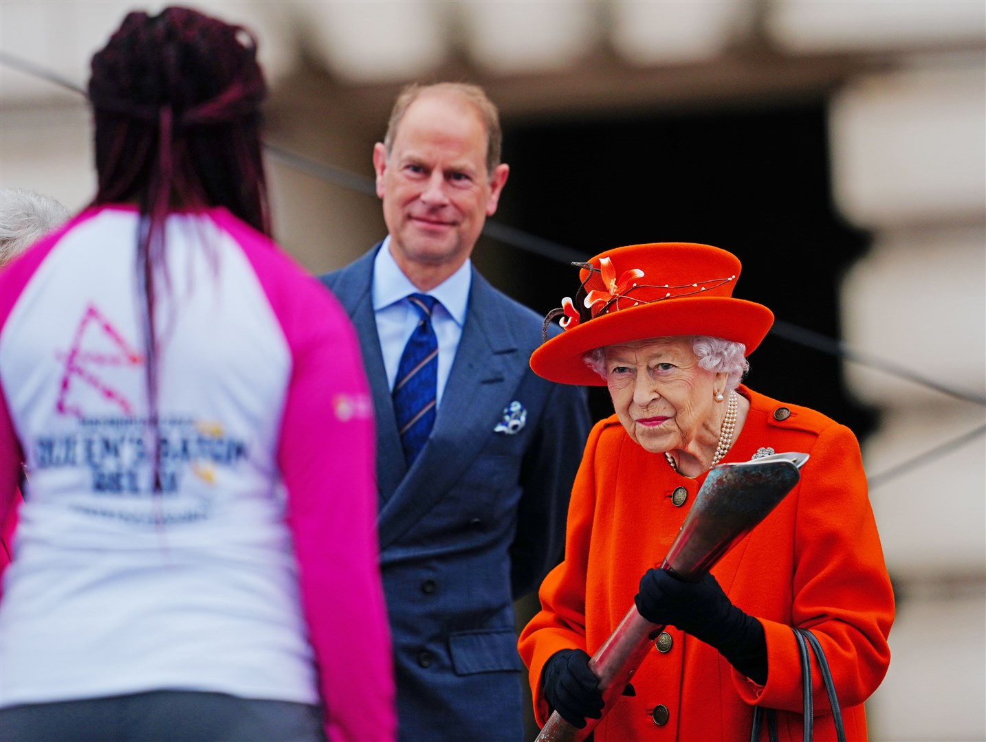 The Queen passes her baton to British parasport athlete Kadeena Cox to launch the global relay for the Commonwealth Games being staged in Birmingham (Victoria Jones/PA)