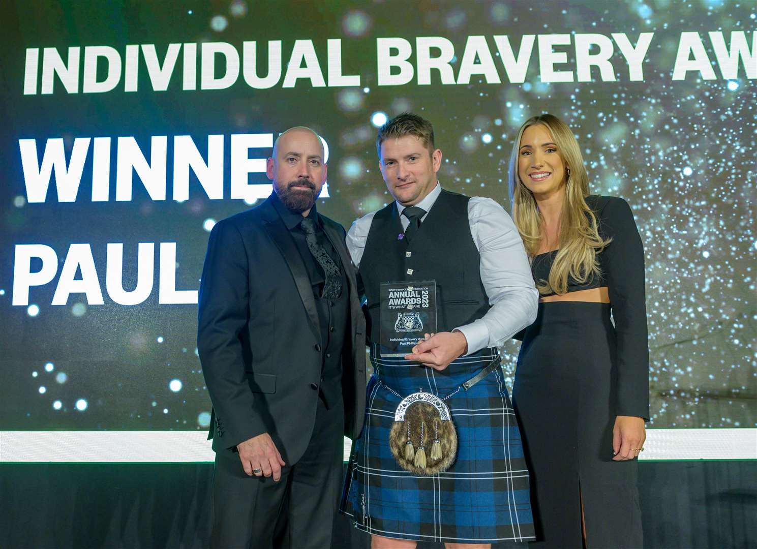 BRAVE OFFICER: Paul Phillips (centre) receives the Individual Bravery Award from David Kennedy, general secretary of the SPF, and event host Amy Irons. Picture: Sandy Young/scottishphotographer.com