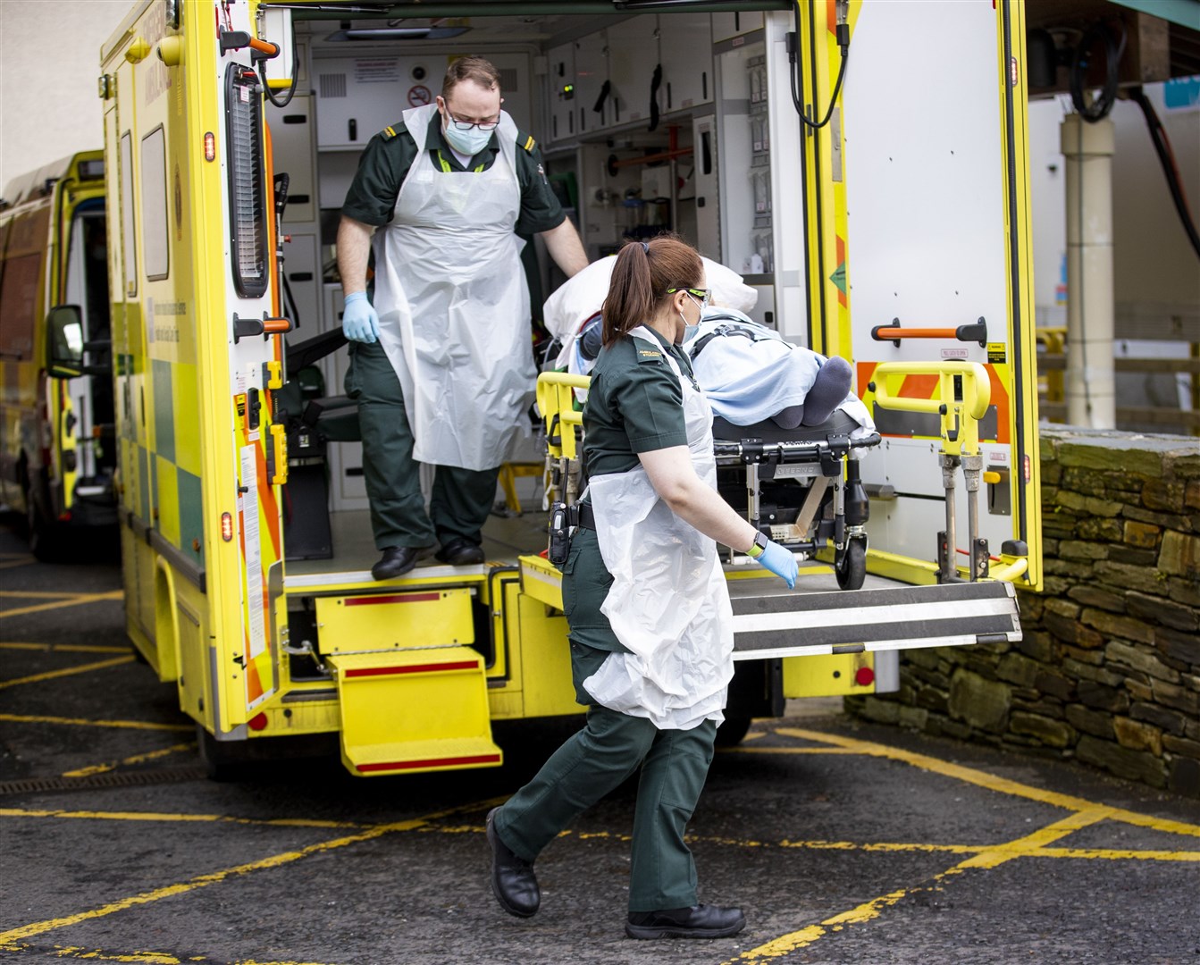 Ambulance staff deliver a patient to hospital (Liam McBurney/PA)