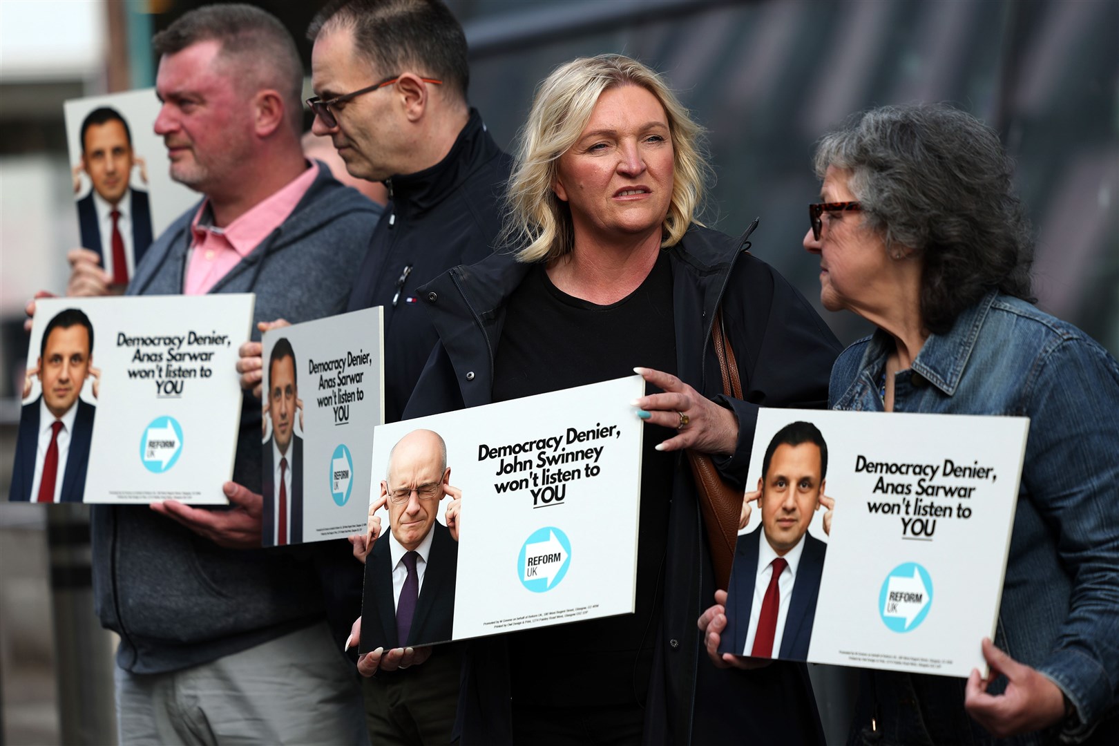 Reform UK protesters accuse John Swinney and Anas Sarwar of being ‘democracy deniers’ (Jeff J Mitchell/PA)