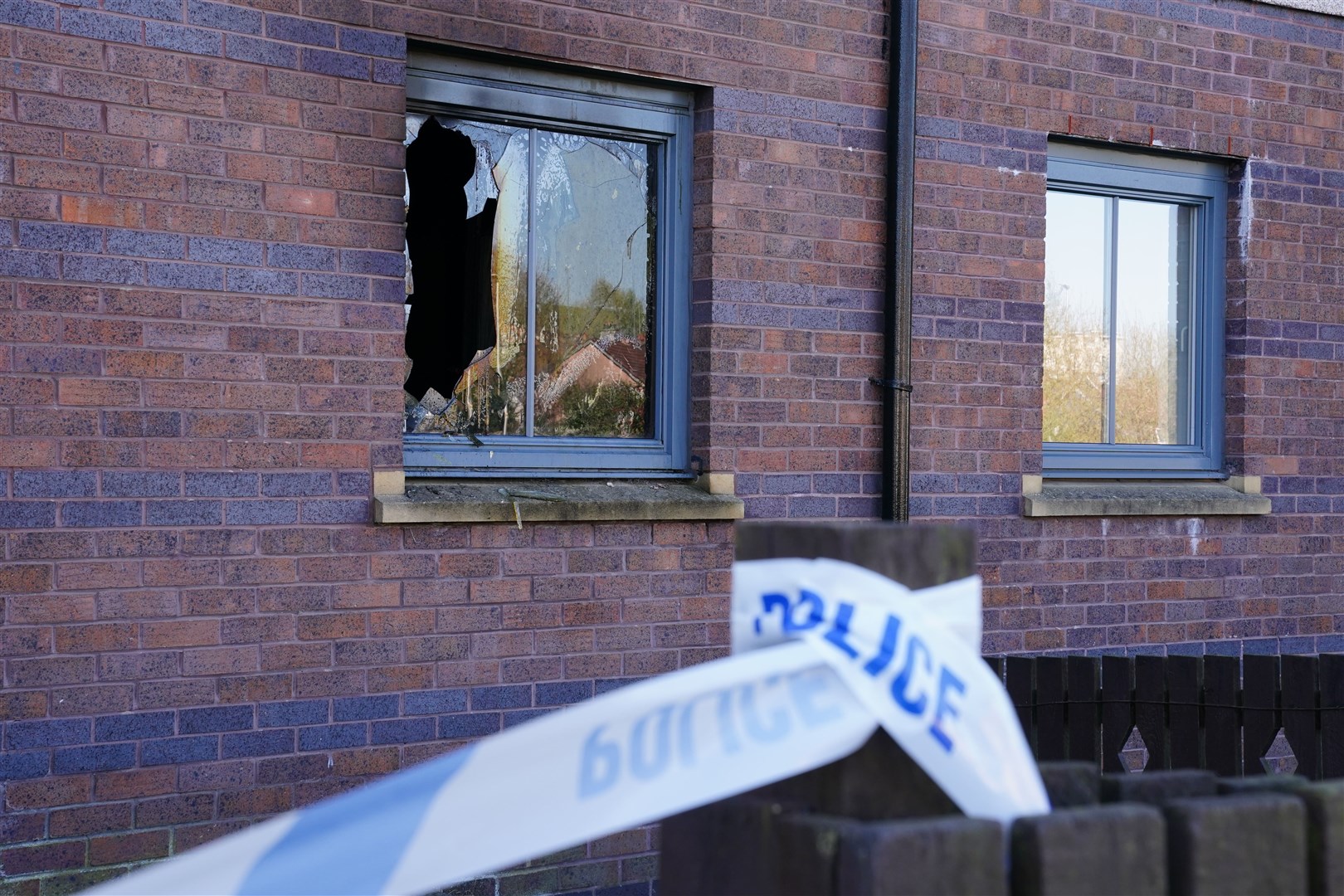 Damage could be seen to some windows at the block of flats (Jane Barlow/PA)