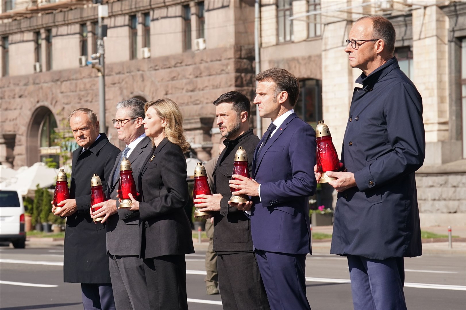 The leaders place candles at the memorial in Maidan Square (Stefan Rousseau/PA)