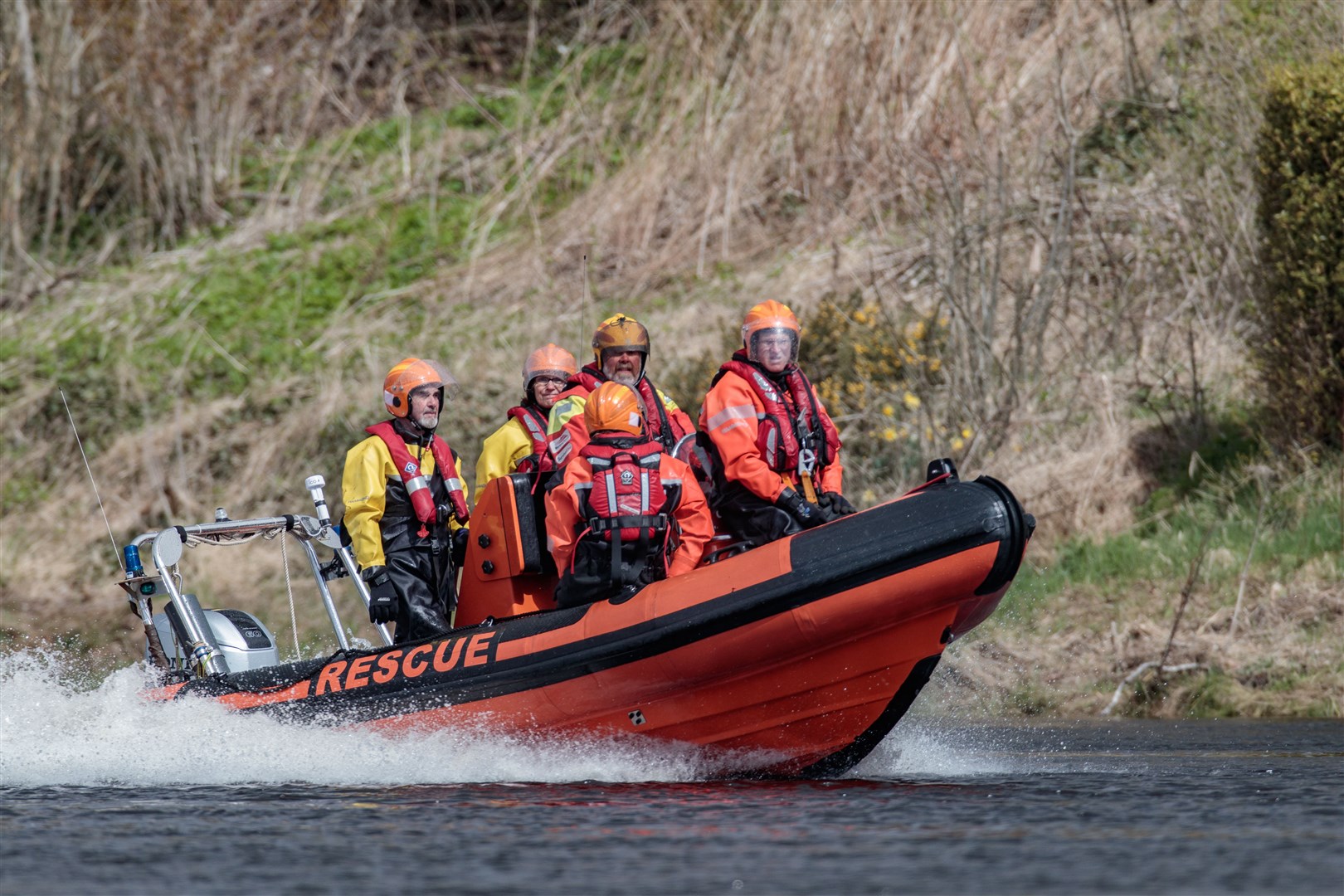 Crew members in action on their existing boat.