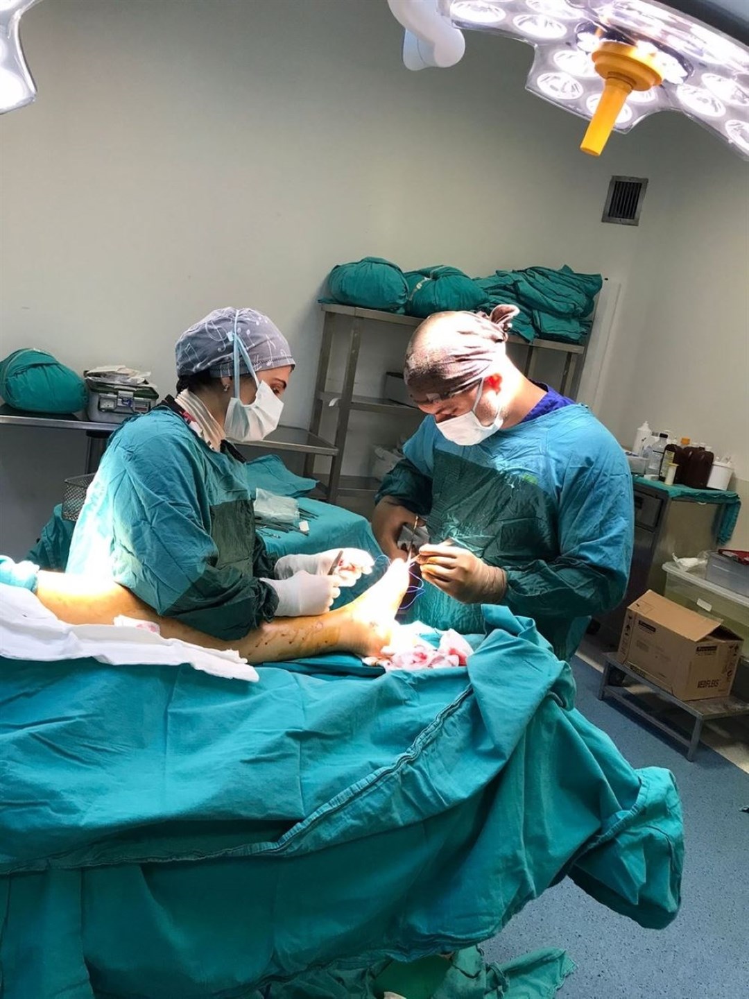 Mr Dirlik and his assistant performing a surgery (Noyan Dirlik/PA)