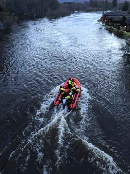 Firefighters on the River Spey near to the caravan park