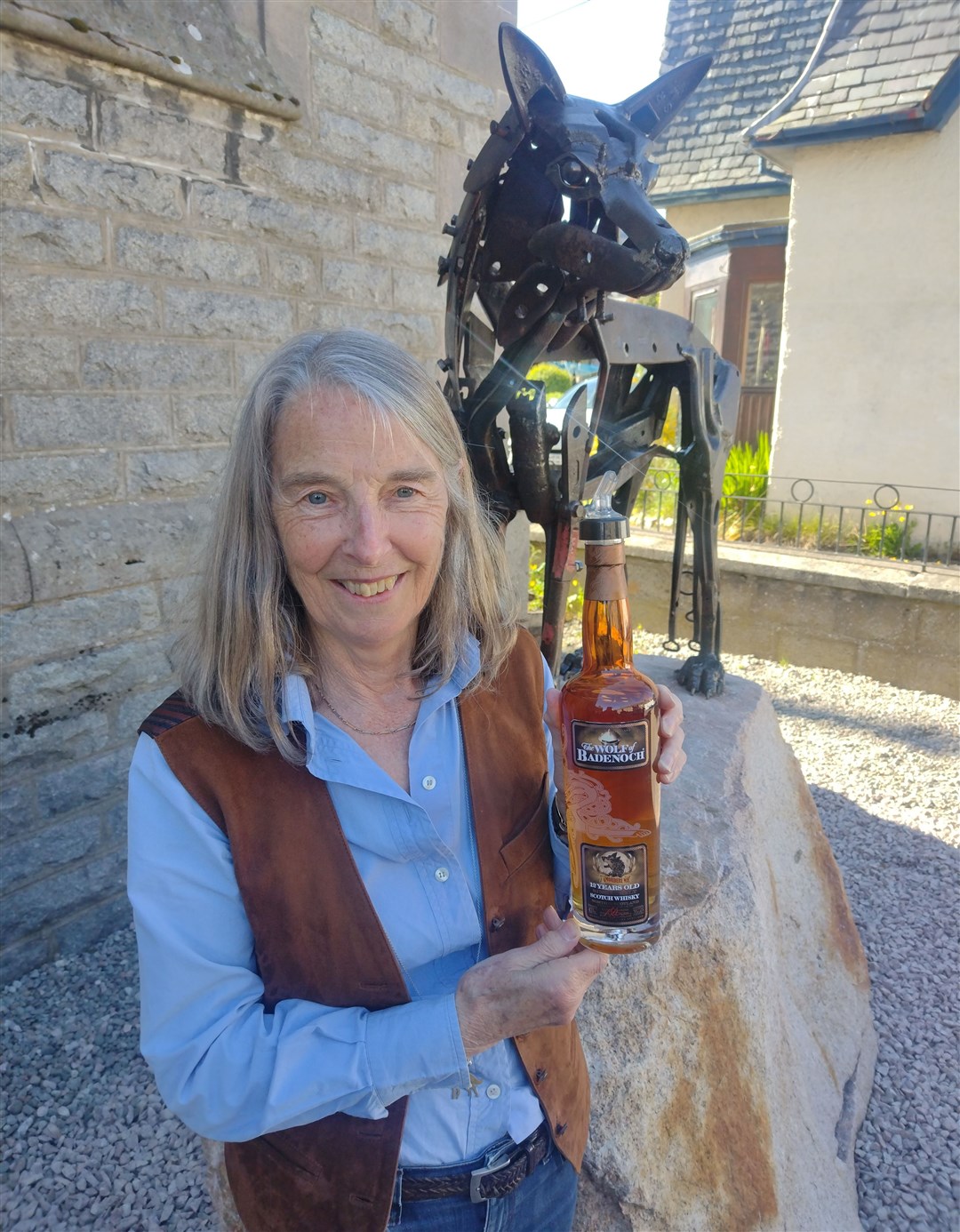 SLAINTE, BOBBY! Shirley Nield with the 'Wolf of Badenoch' whisky she acquired for him (from Italy!) several years ago. It was served up at Tuesday night's talk in Talla nan Ros.
