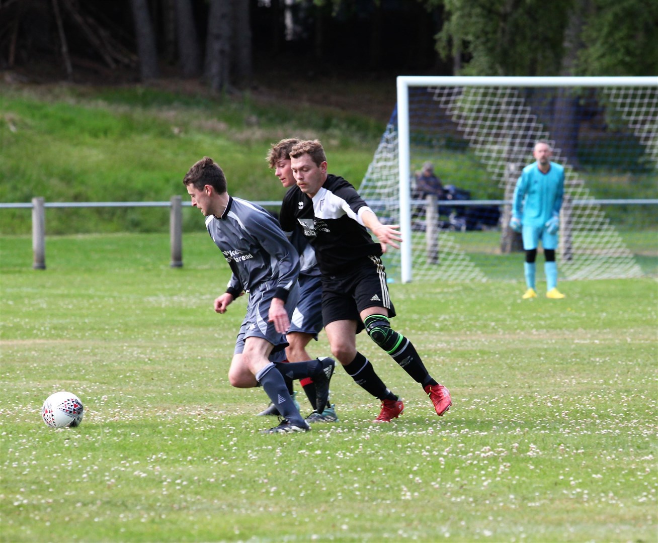 Sean Christie (FC Abernethy) finds his way to goal blocked by Connor Macleod (Boat of Garten) and team-mate. Picture: Frances Porter.