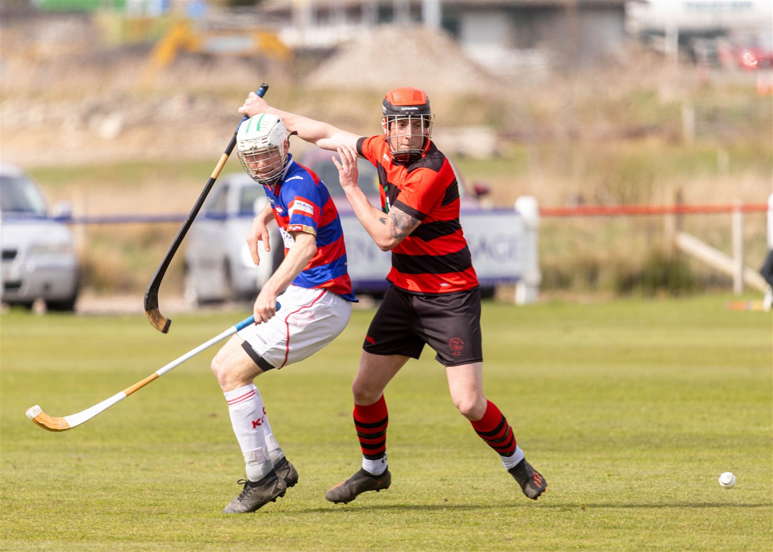 Kingussie's George Taylor-Ramsay and Oban's Ross Campbell eye up the ball.