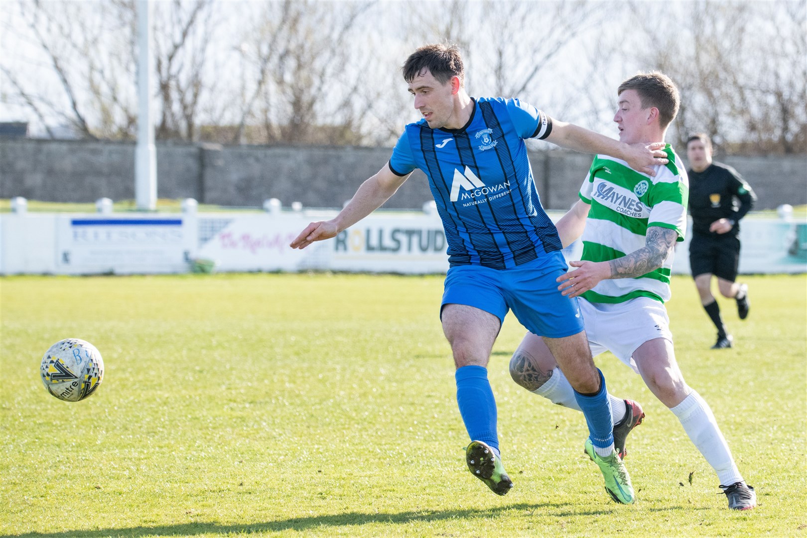 Strathspey captain James McShane hold off Buckie Thistle's Kyle Macleod...Buckie Thistle FC (5) vs Strathspey Thistle FC (0) - Highland Football League - Victoria Park, Buckie 02/04/2022...Picture: Daniel Forsyth..