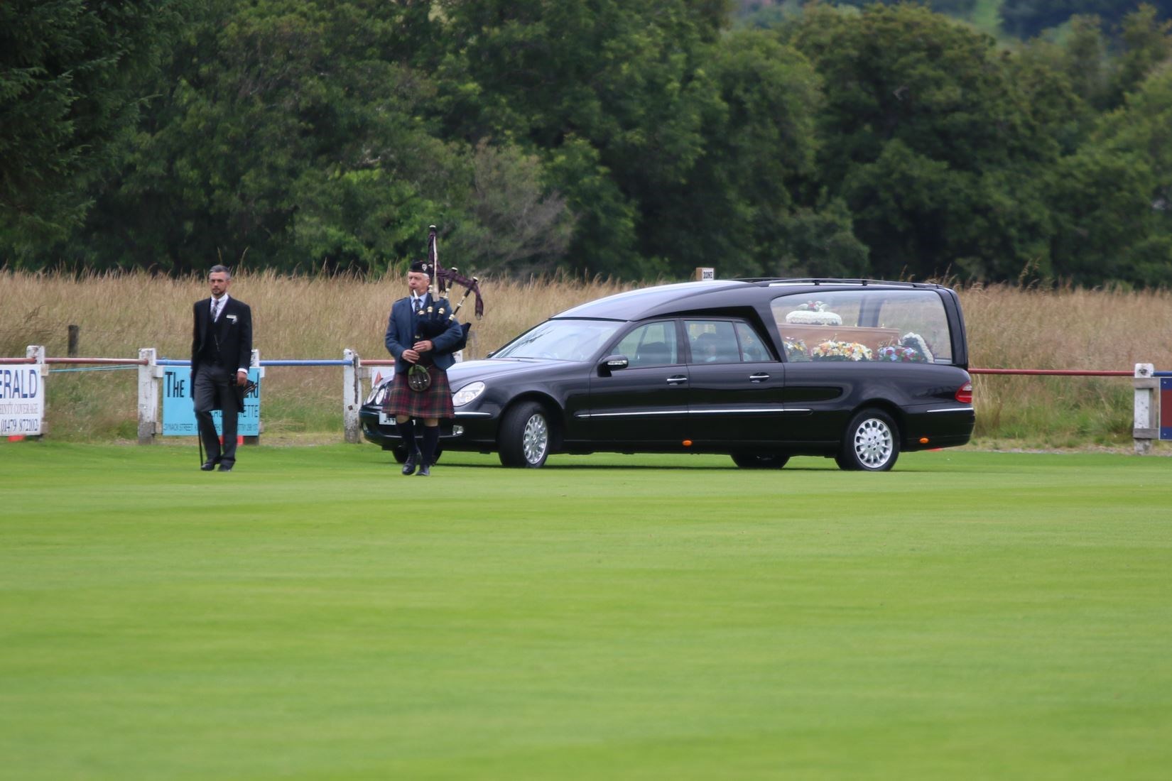 Piper Sandy MacDonell leads the cortege round the Dell today. (Aidan Woods).
