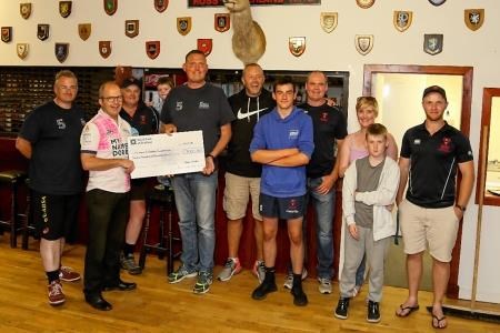 Doddie Weir receives a cheque for £7000 from Ross Sutherland Rugby Club committee member Alan McLean. Picture: Peter Carson