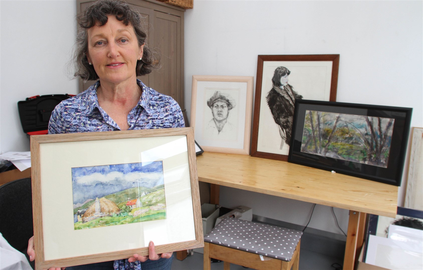 Sandra Douglas shows off some of the art works by her late husband David.
