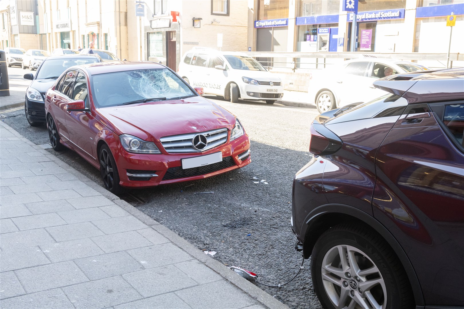 The aftermath of the incident involving two cars and a motorbike on Elgin High Street. Picture: Beth Taylor.