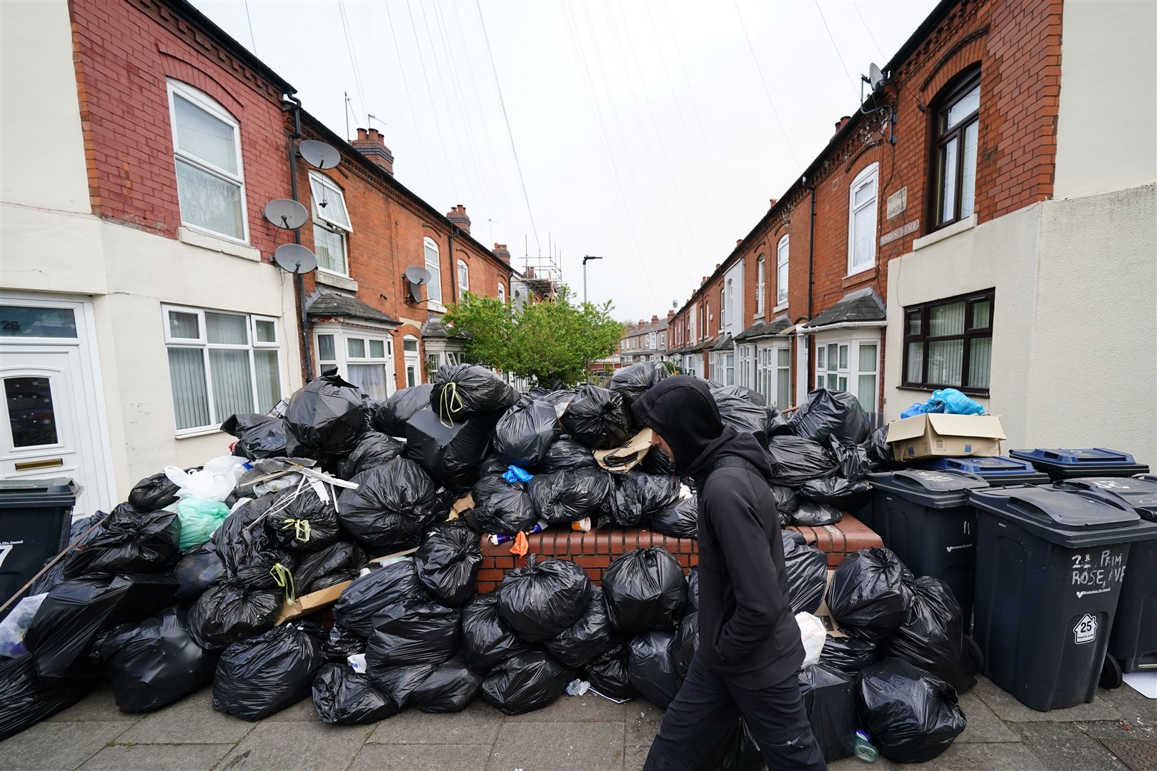 A huge pile of black bin bags in between two rows of houses in Poplar Road in Birmingham (Jacob King/PA)