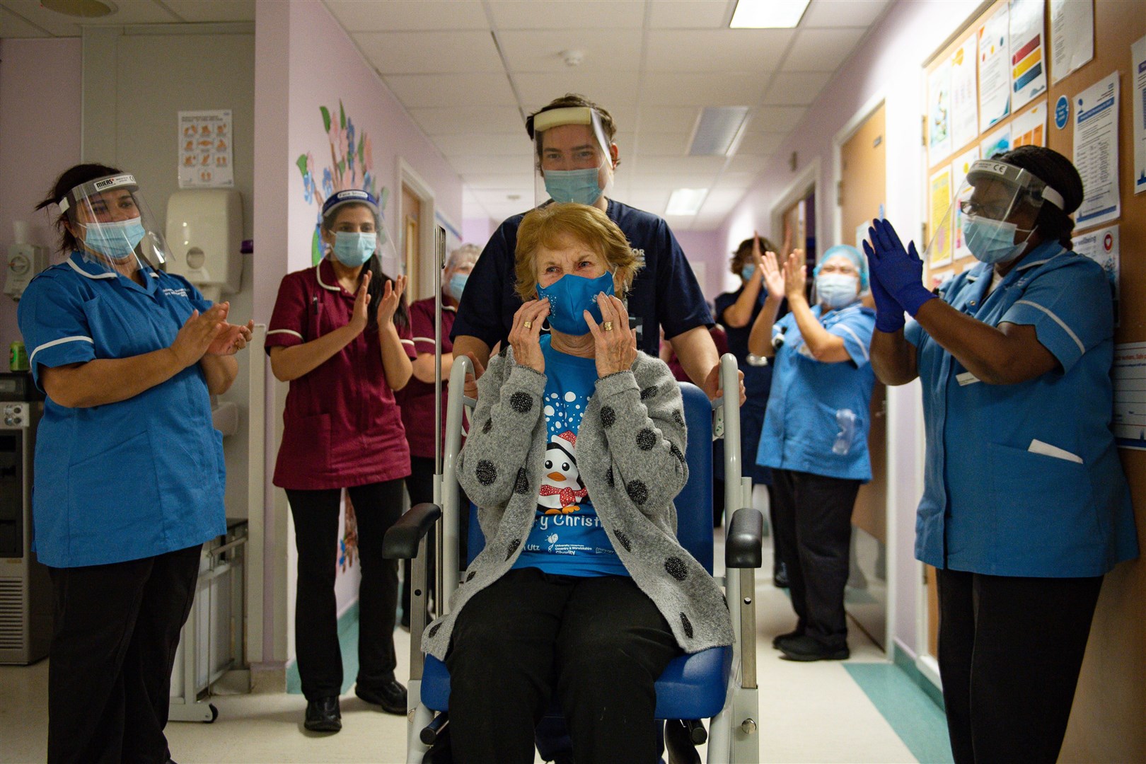 Margaret Keenan is applauded by staff as she returns to her ward after receiving the Pfizer/BioNTech Covid-19 vaccine (Jacob King/PA)