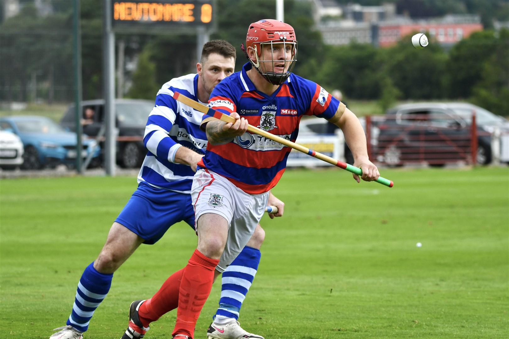 Old adversaries Savio Genini and Newtonmore's Steven MacDonald challenge for the ball.