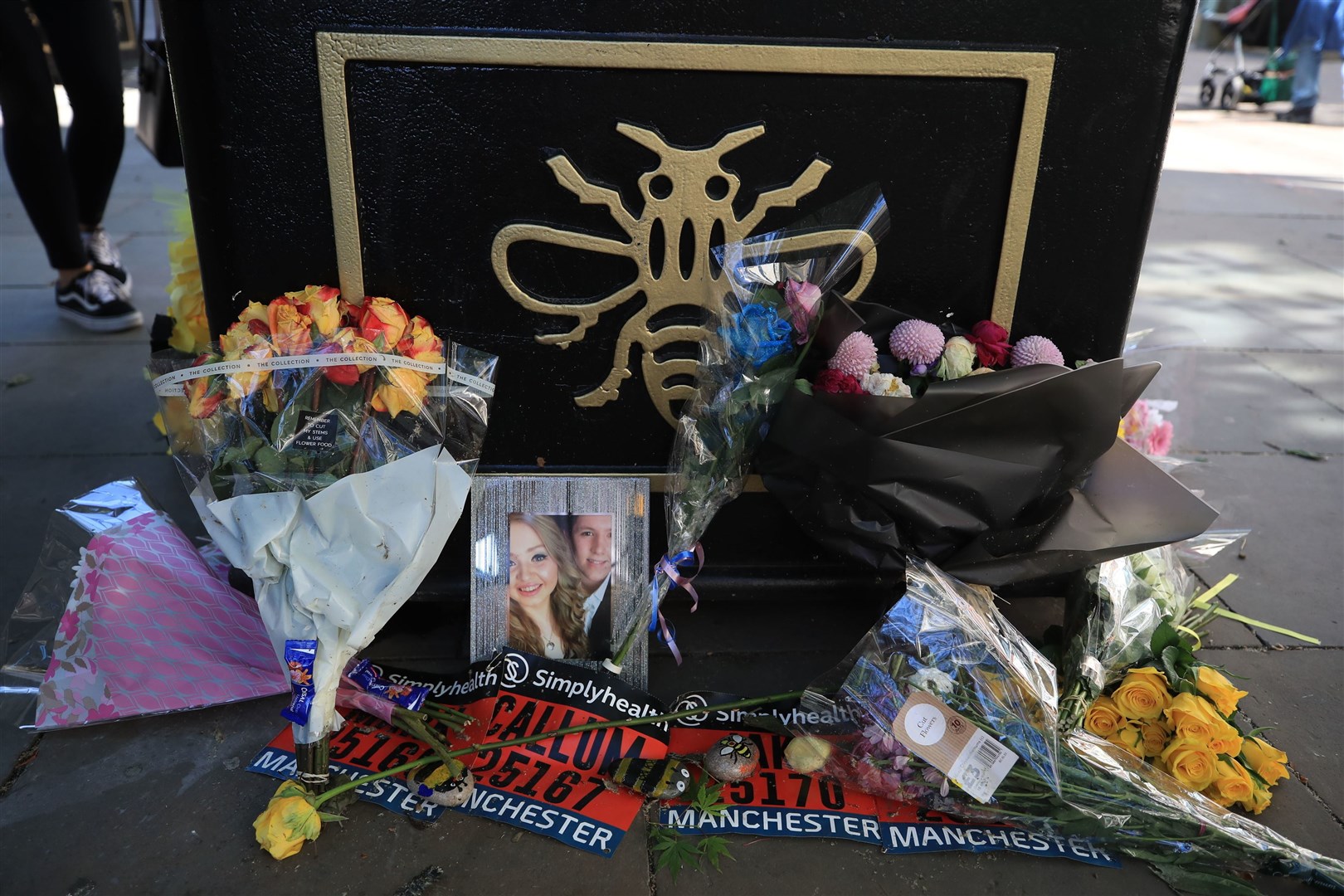 Flowers and a picture of Chloe Rutherford and Liam Curry, who were killed in the Manchester Arena attack, left against a Tree of Hope in Manchester (Peter Byrne/PA)