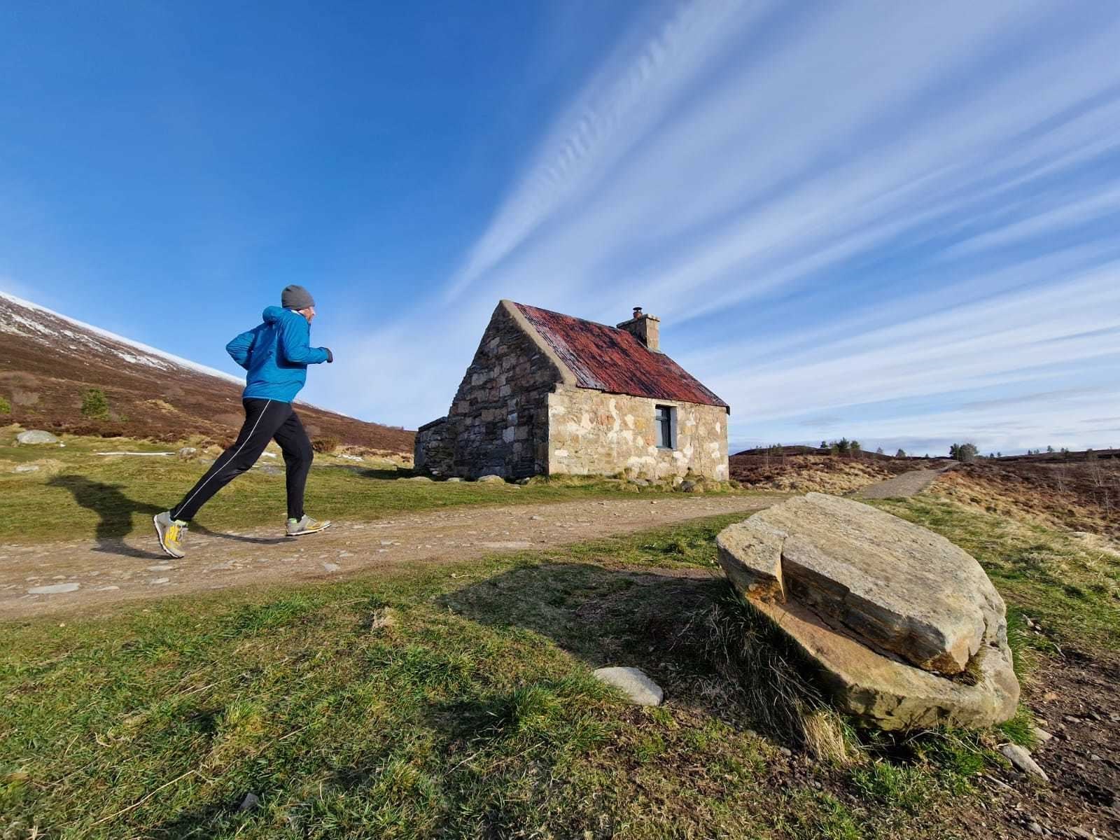 Striding past Ryvoan bothy on a run in the Cairngorms National Park.